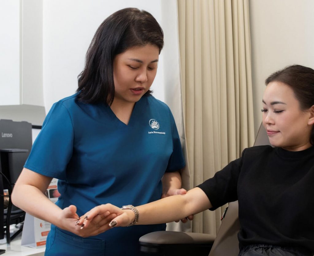 doctor-with-patient-checking-hands-mobile | Aaria Rheumatology